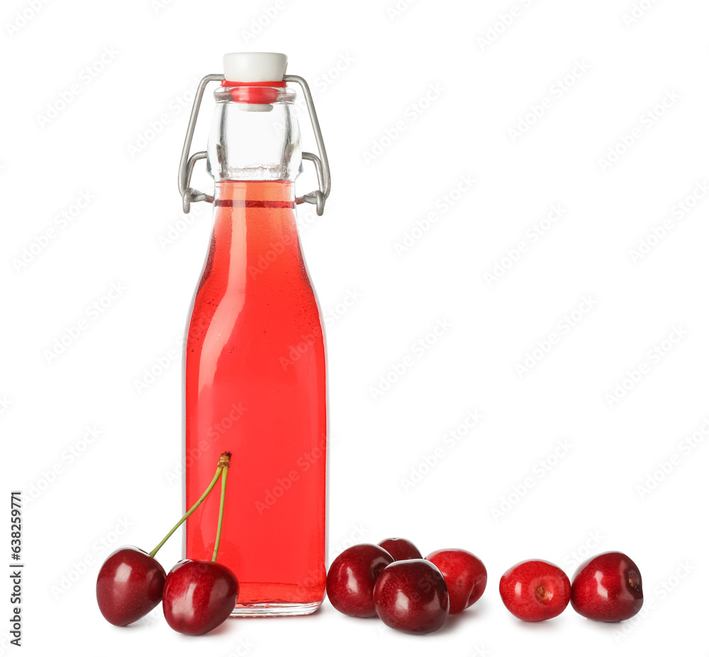 Bottle of sweet cherry liqueur with fresh berries on white background