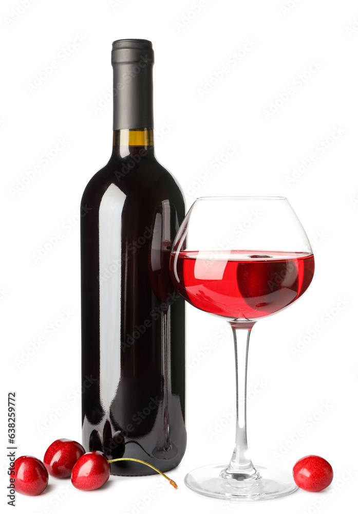 Glass and bottle of sweet cherry liqueur with berries on white background