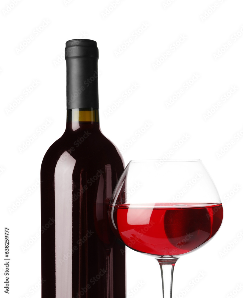 Glass and bottle of sweet cherry liqueur on white background