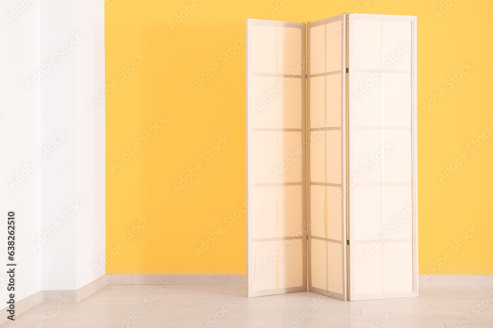 Folding screen near orange wall