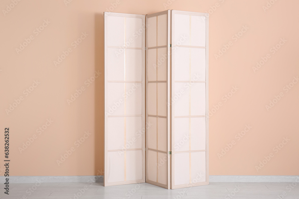 Folding screen near beige wall