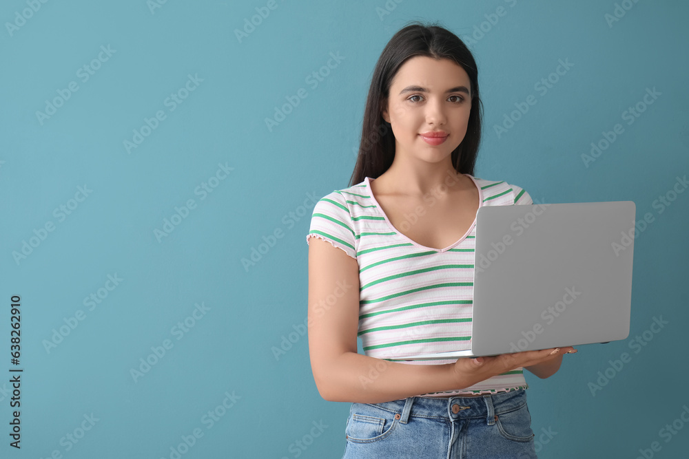 Happy female programmer working with laptop on blue background