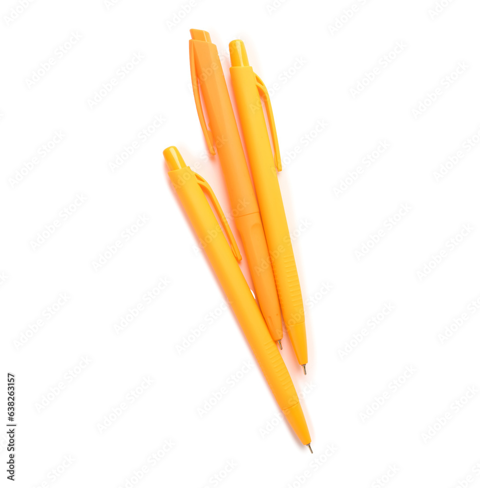 Orange pens on white background