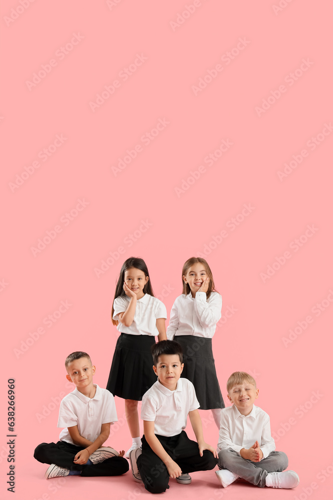 Little school children on pink background