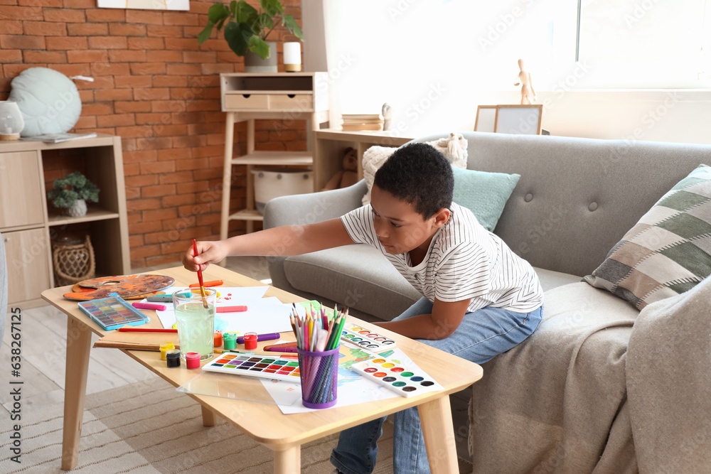 Little African-American boy drawing at home