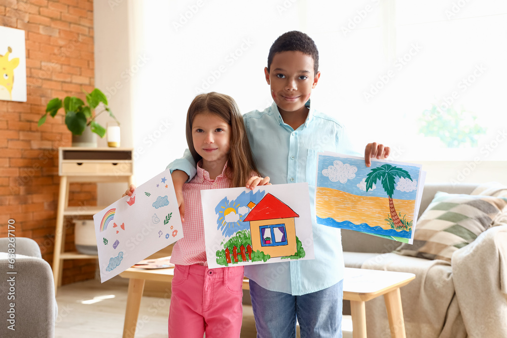 Cute little children with drawings at home