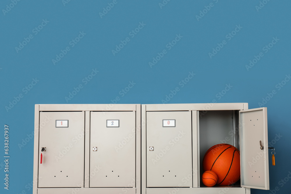 Modern locker with balls near blue wall