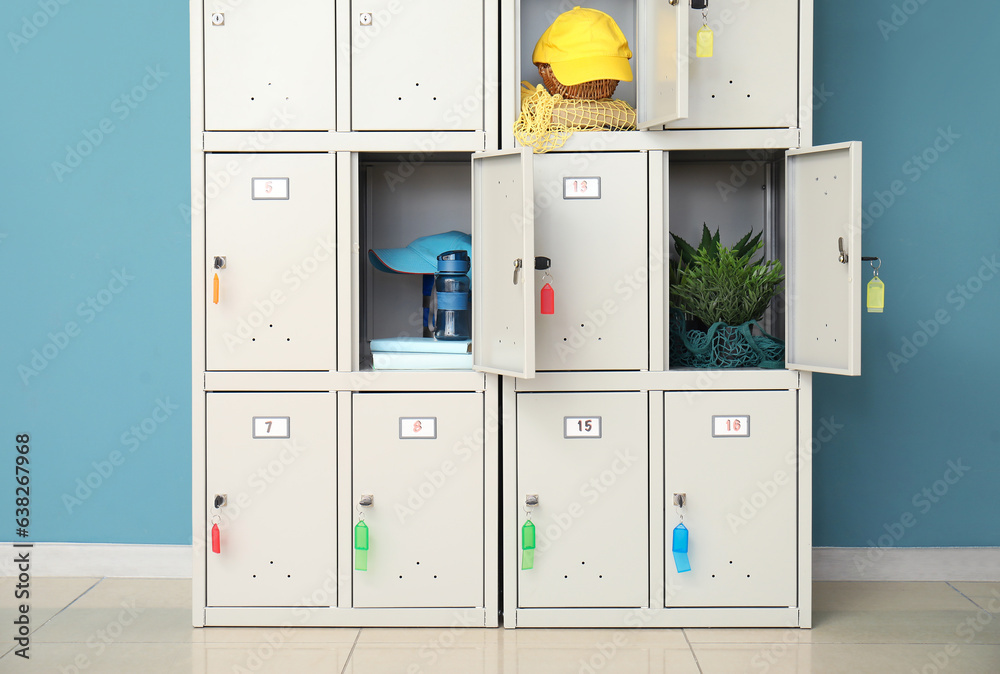 Modern locker with things near blue wall