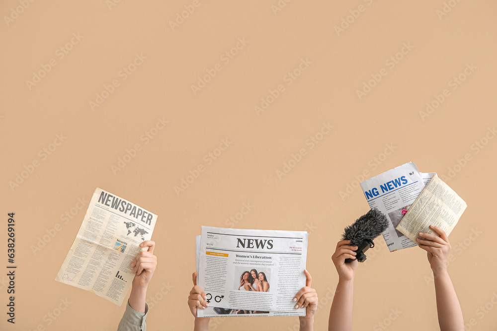 Female hands with different newspapers and microphone on color background