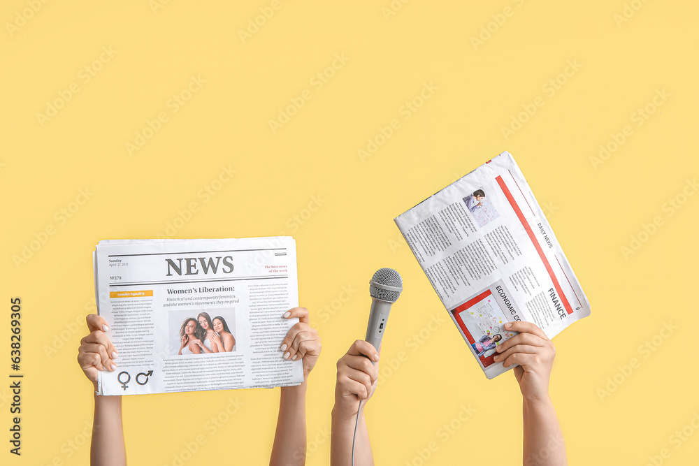 Female hands with newspapers and microphone on color background