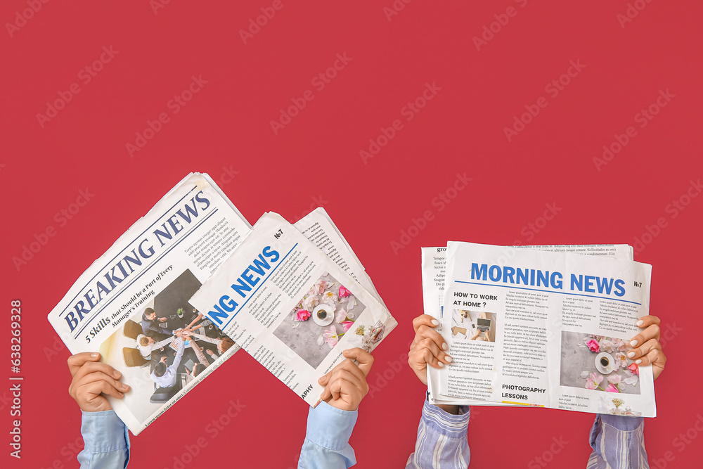 Female hands with newspapers against color background