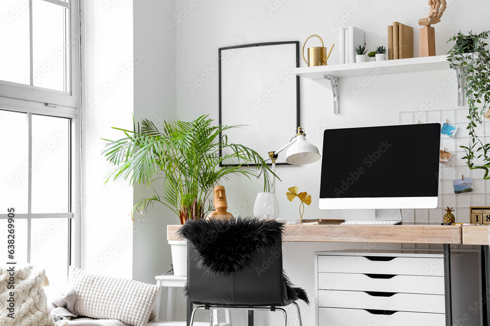 Interior of modern office with workplace and houseplants