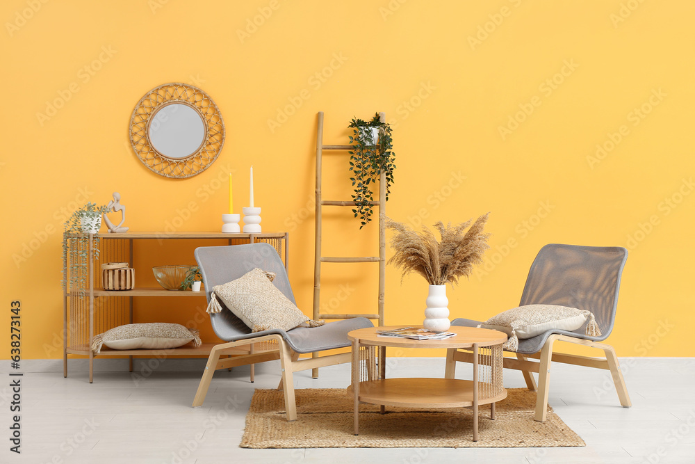 Stylish interior of modern living room with magazines and pampas grass on table