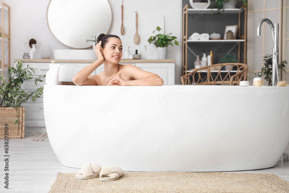 Young woman taking bath at home