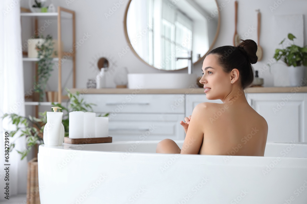 Young woman taking bath at home