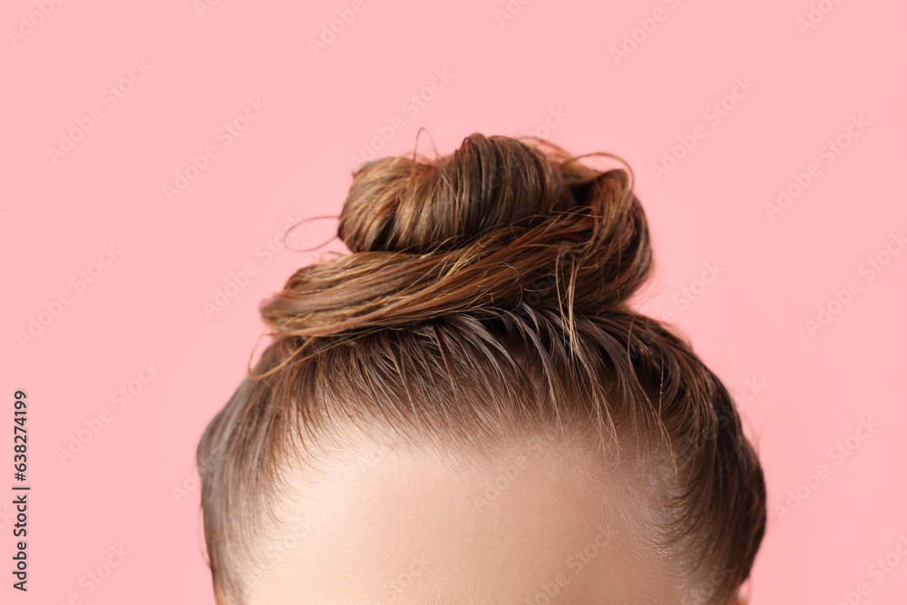 Young woman after washing hair on pink background, closeup