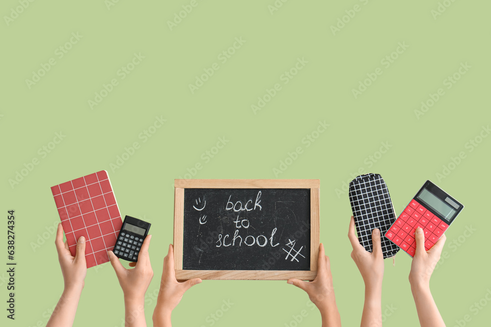 Female hands holding different stationery and blackboard with text BACK TO SCHOOL on green backgroun