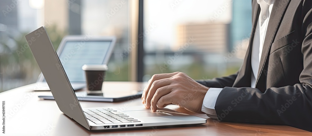 Business professionals working on a laptop and other devices with a blurred home background