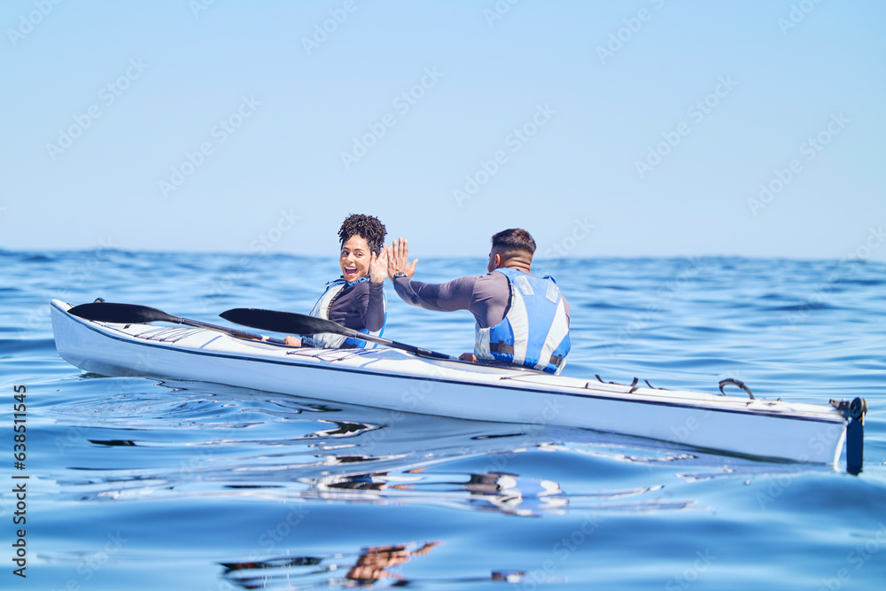 Water, man and woman in kayak with high five on lake, beach or river in sports challenge on vacation