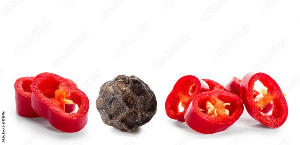 Cut chili pepper and peppercorn on white background