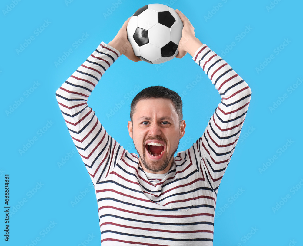 Screaming man with soccer ball on blue background