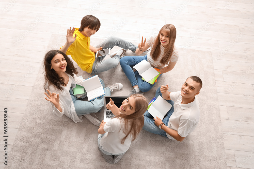 Group of students doing homework in room, top view