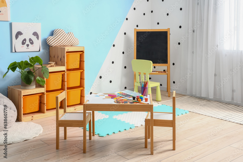 Interior of childrens room with art supplies on table