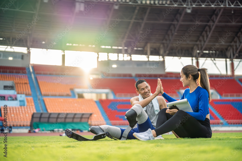 Asian athlete with prosthetic blades and trainer workout in stadium. 