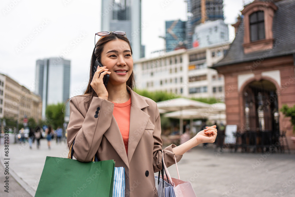 Asian beautiful women talking on phone while walk in department store. 