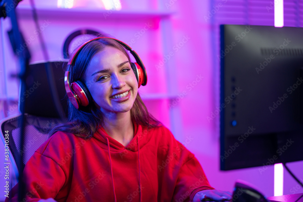 Caucasian e-sport woman gamer playing online video game on computer. 