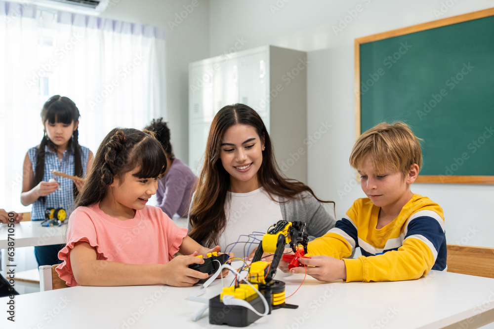 Caucasian woman teacher teaching a lesson to kids at elementary school. 