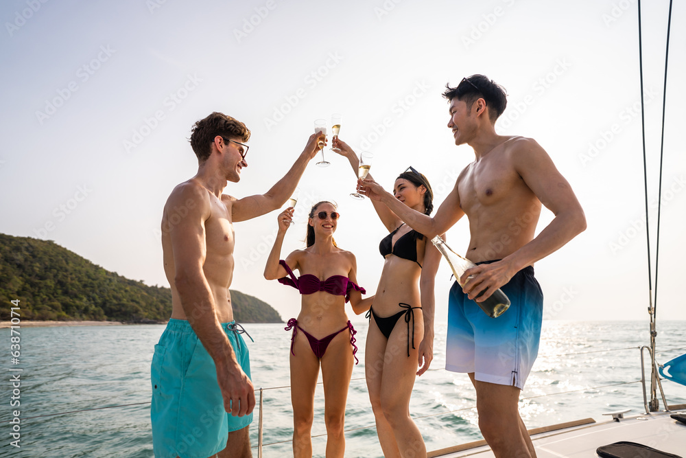 Group of diverse friends drink champagne while having a party in yacht. 