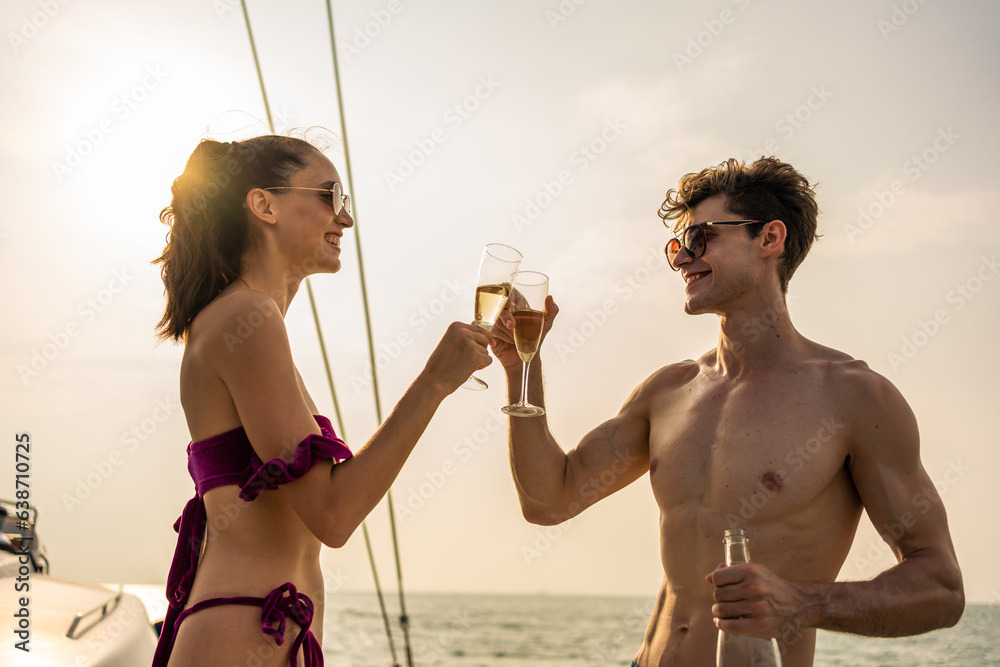 Caucasian young couple drink a bottle of beer, having party in yacht. 