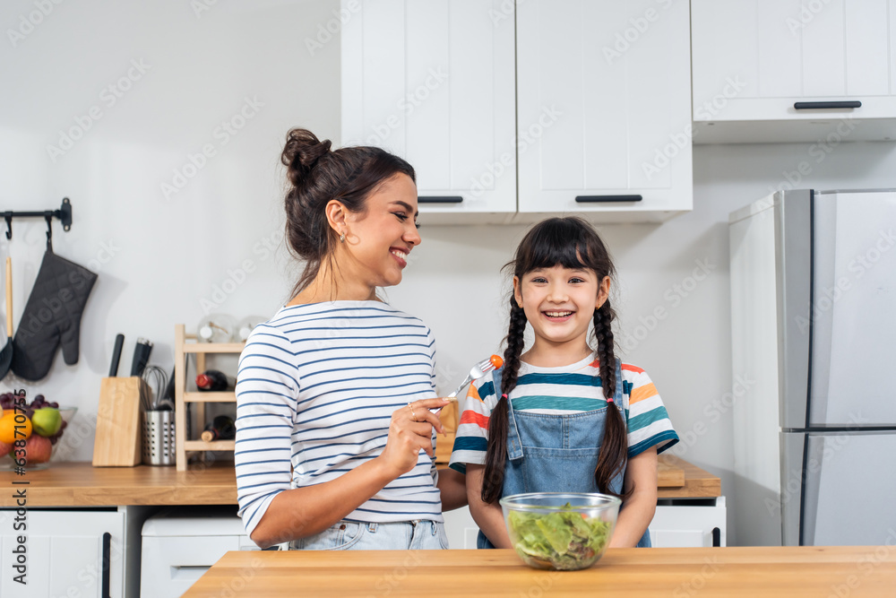 Portrait of Caucasian mother and young girl child looking at camera. 