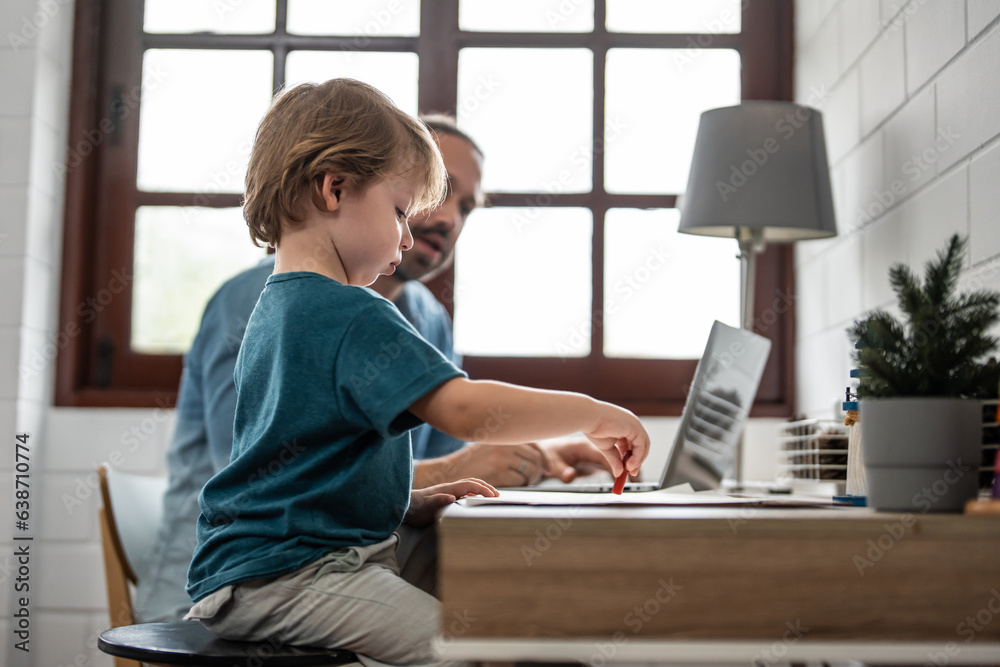 Caucasian attractive father use laptop computer with young son beside. 