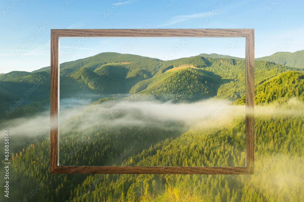 Wooden frame and beautiful mountains with fog in morning