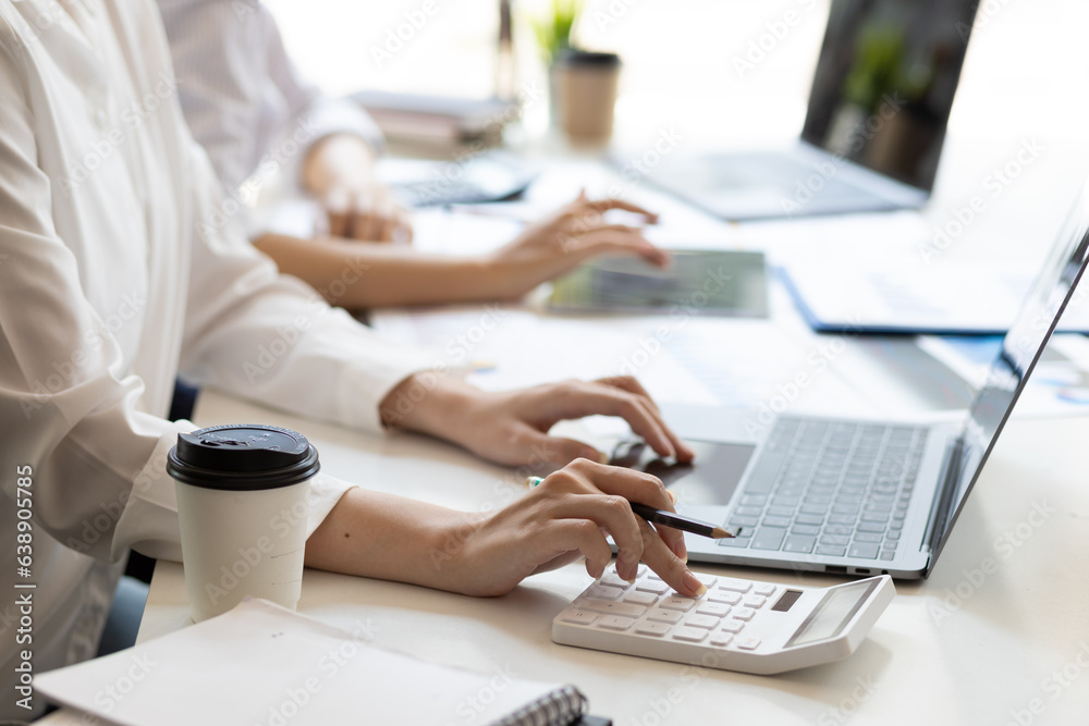 Businesswoman colleague discuss planning, budget management, accounting, business in office.