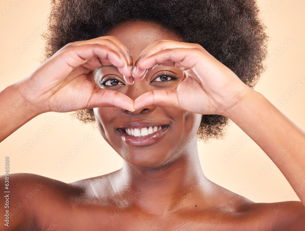 Smile, portrait and a black woman with heart hands on a studio background for love or support. Happy