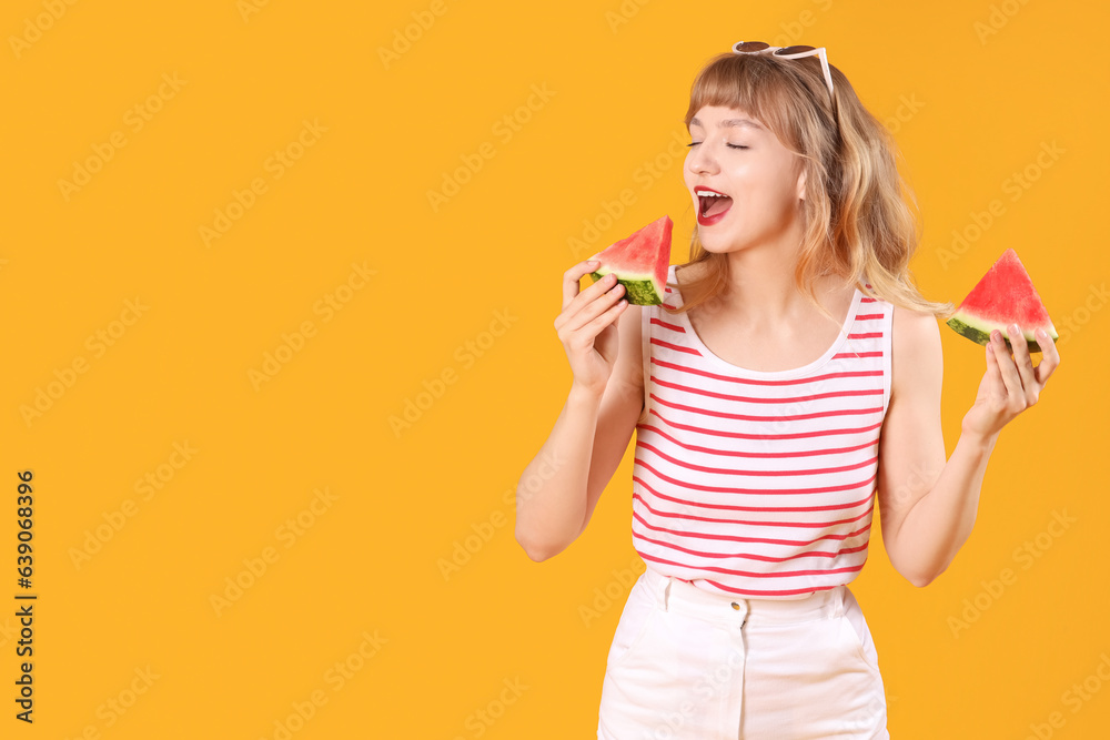 Young woman with slices of fresh watermelon on orange background