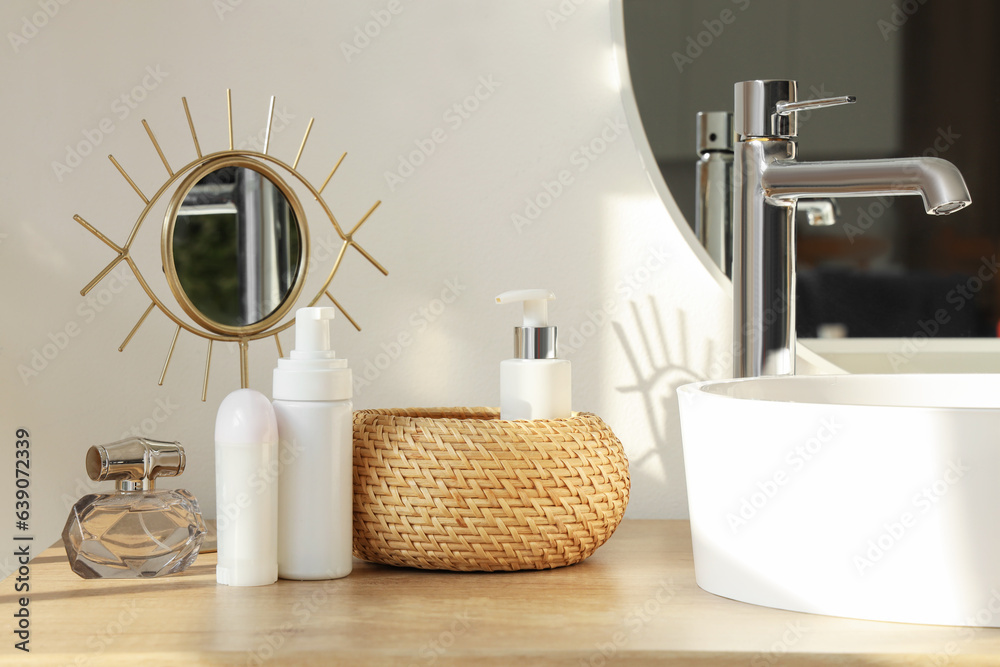 Bath accessories with mirror on table in room