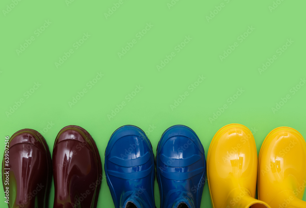 Different gumboots on green background