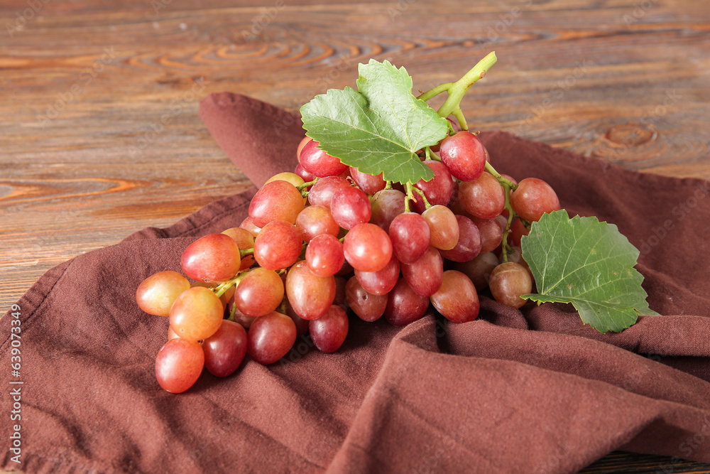 Tasty ripe grapes on wooden background