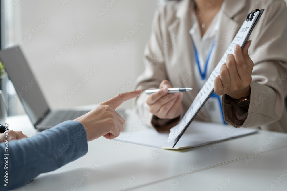 Businesswoman, office worker working using laptop and mobile phone in real estate accounting analysi