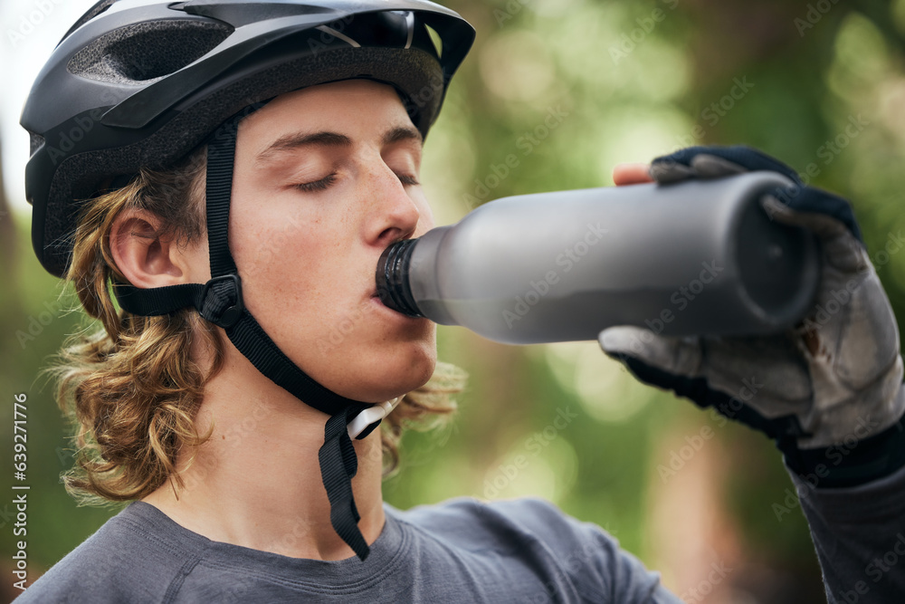 Forest, biker and man with a water bottle, wellness and exercise with workout, refreshing and break.