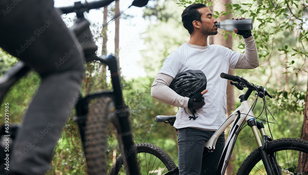 Forest, bike and man drinking water, exercise and fitness with workout, refreshing and wellness. Hea