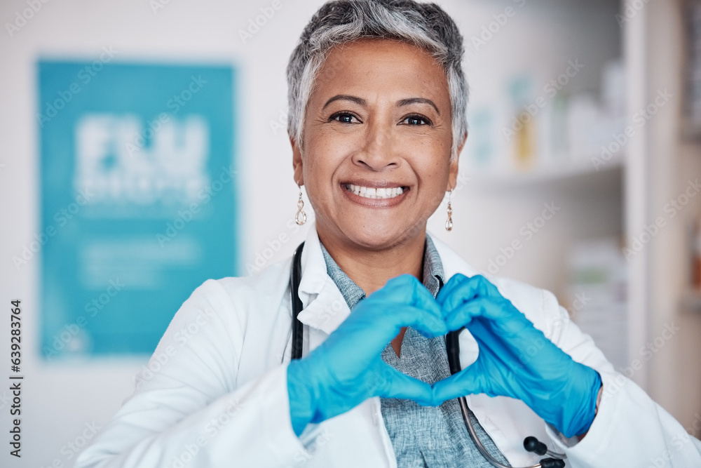 Senior, happy woman and portrait of doctor with heart hands in healthcare, service or love at hospit