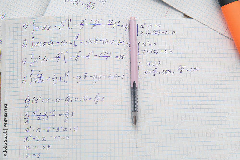 Open copybook with math formulas and pen as background, closeup