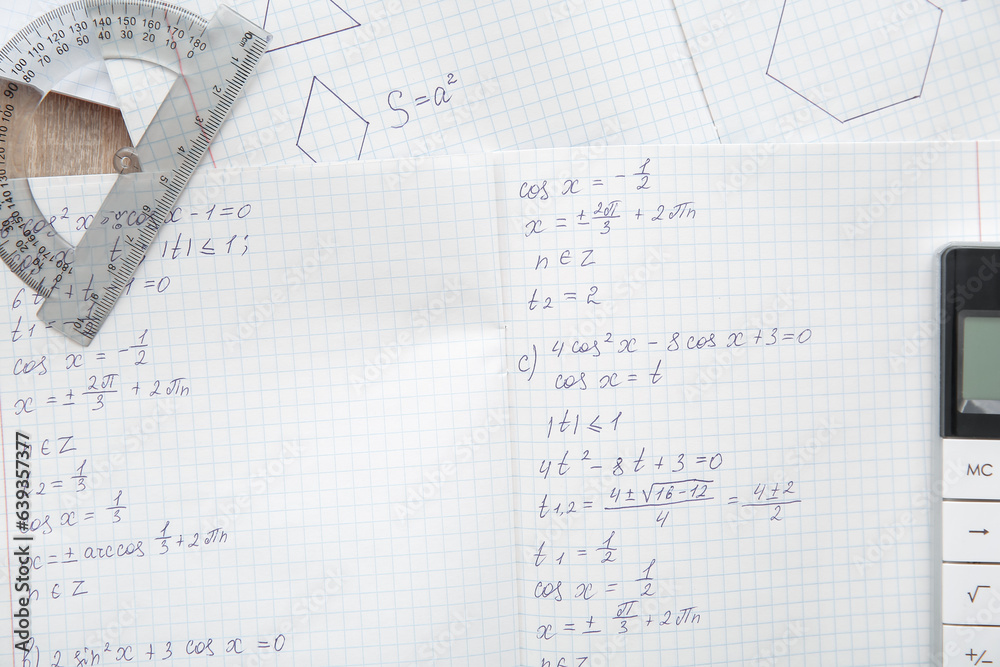 Open copybooks with math formulas as background, closeup