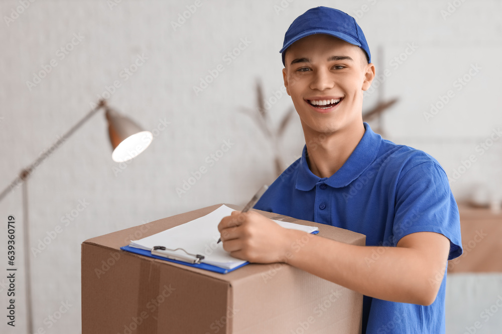 Young courier with parcel and clipboard in room