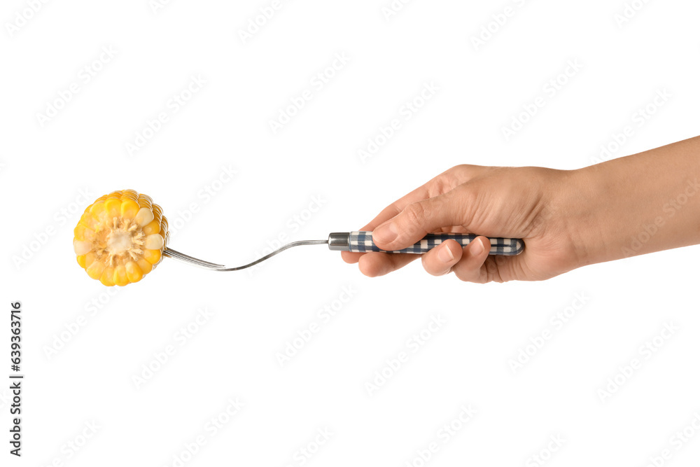 Woman holding fork with boiled corn cob on white background